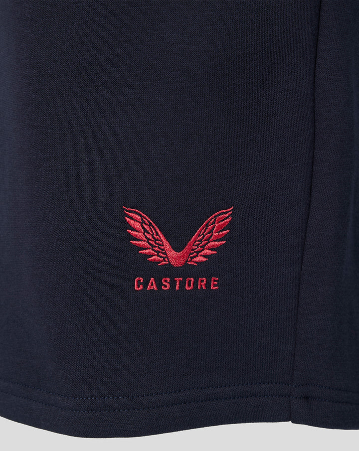 Close-up of navy fleece fabric with red Castore logo embroidery near hem
