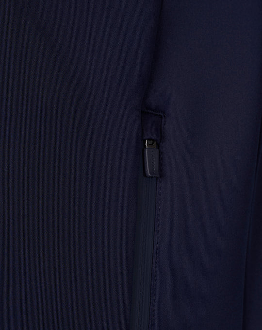Close-up of navy Travel hoodie showing a zippered side pocket detail.