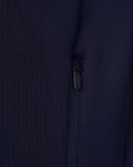 Close-up of navy Travel hoodie showing a zippered side pocket detail.