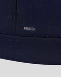 Close-up of navy fabric with PROTEK branding and scattered water droplets.