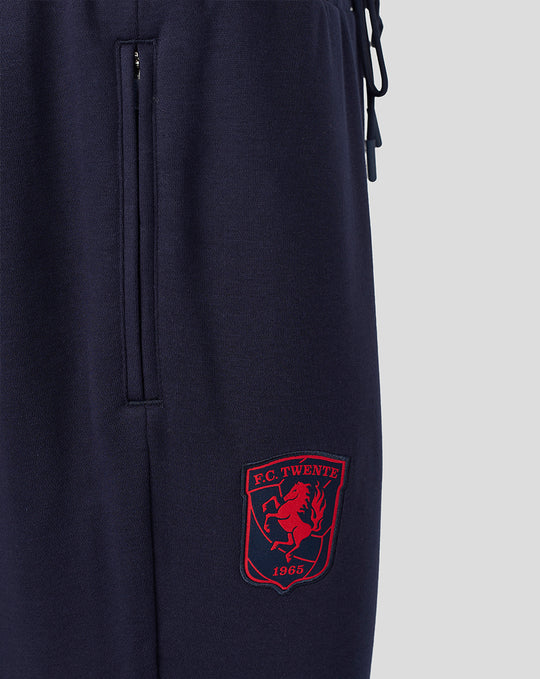 Navy FC Twente travel fleece joggers with a side zip pocket and red club crest on the leg.