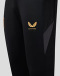FC Twente black training pants with orange accents and a gold Castore logo on the thigh