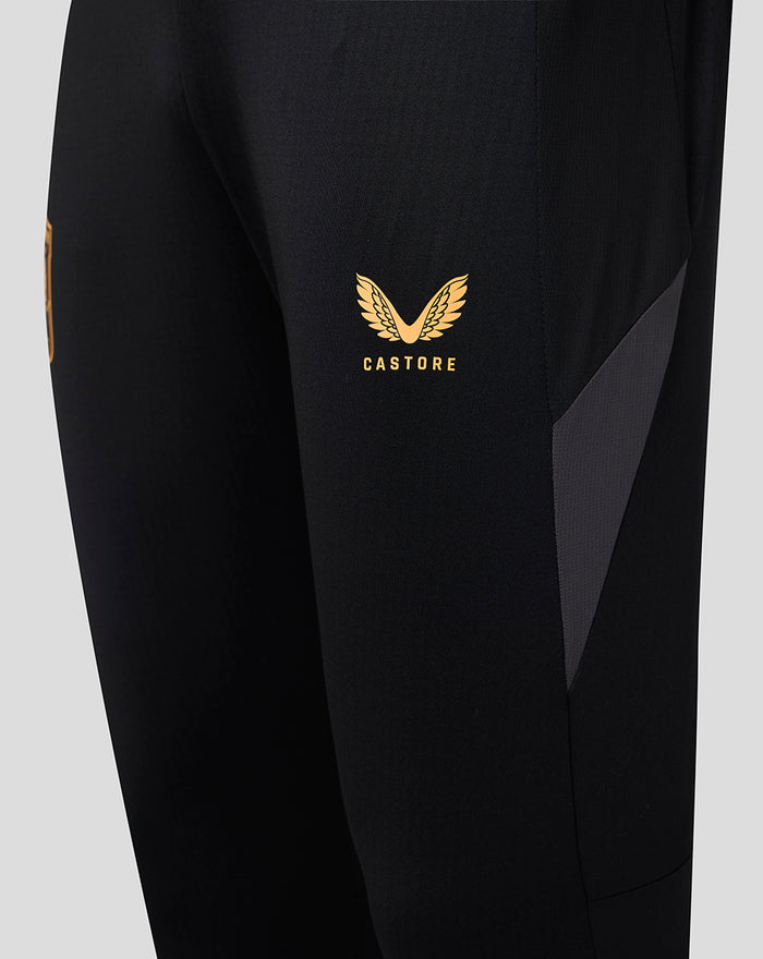 FC Twente black training pants with orange accents and a gold Castore logo on the thigh