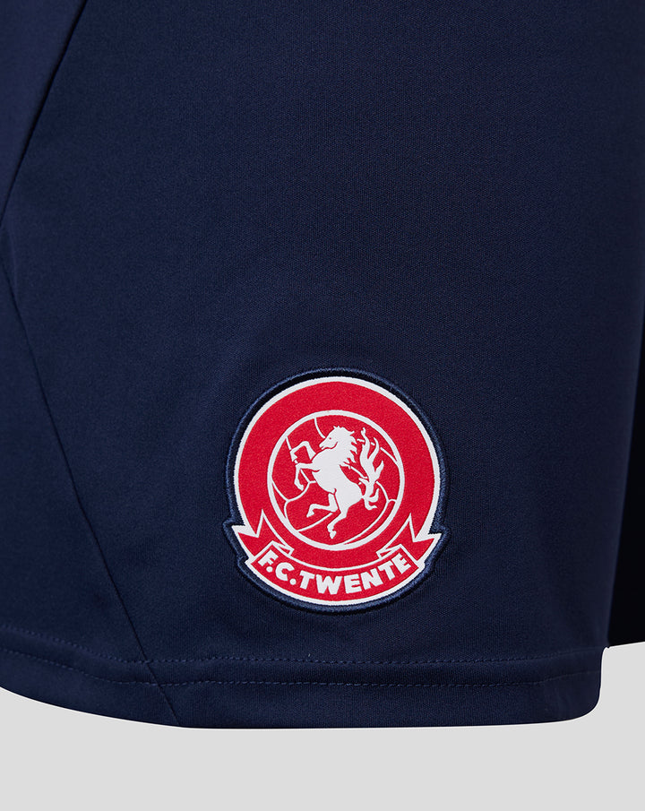 Close-up of the FC Twente crest patch on navy Vierde Short 26/27 Junior.