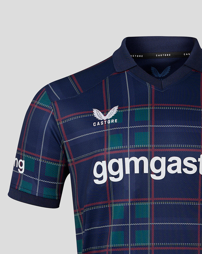 Close-up of navy FC Twente fourth shirt 26/27 showing the plaid fabric and crest near the chest and collar.