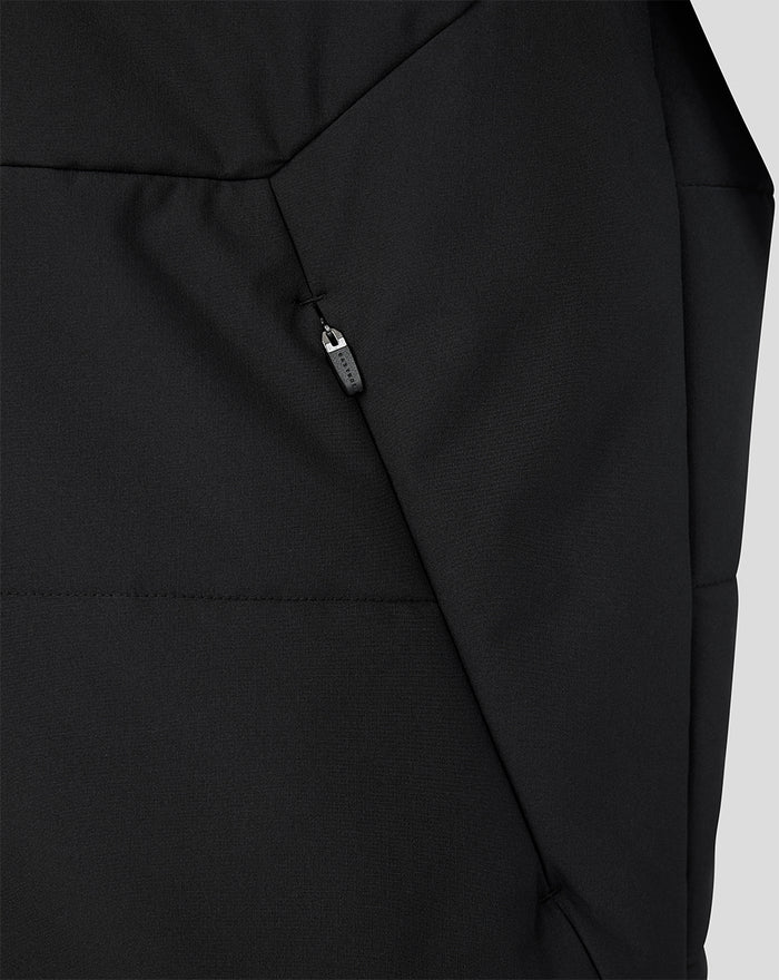 Close up of black FC Twente training gilet detailing a diagonal zip pocket and quilted panels