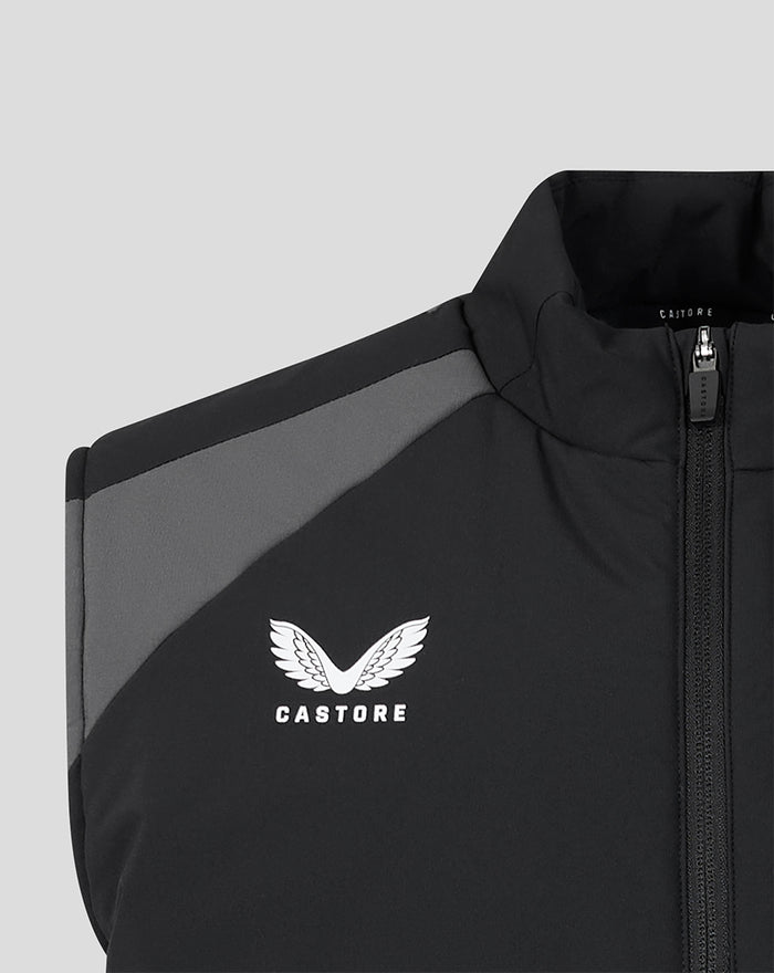 Shoulder close-up of the black training gilet with a grey panel and Castore logo.