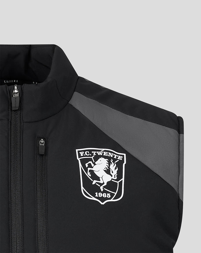 Close-up of the front left chest showing the FC Twente crest on a black training gilet with a zipper.