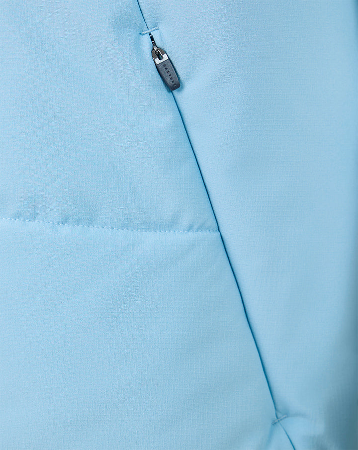 Close-up of zipper and chest seam on light blue training gilet with Castore branding