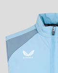 Close-up of light blue padded training gilet with zip front and Castore logo on chest