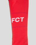 Red FC Twente sock close up showing white lettering and detailed knit pattern