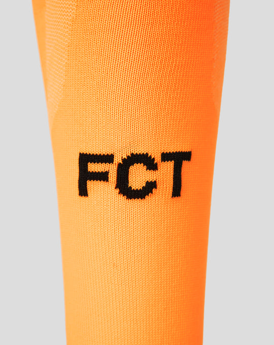 Close up of orange FC Twente keeper sock with FT branding on the leg