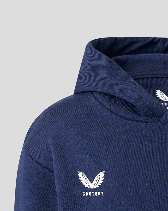 Close-up of navy hoodie shoulder featuring Castore logo and white wing emblem