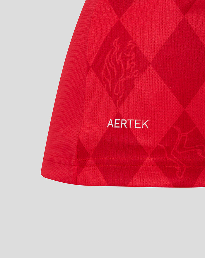 Close up of red FC Twente home shirt fabric with AerTek branding and diamond pattern.