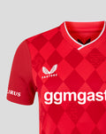 Close-up of the red FC Twente home shirt chest area with Castore logo and bold sponsor text across the front and diamond pattern.