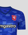 Close-up of FC Twente 25/26 women's away shirt in blue with a stadium wall dot pattern and chest crest