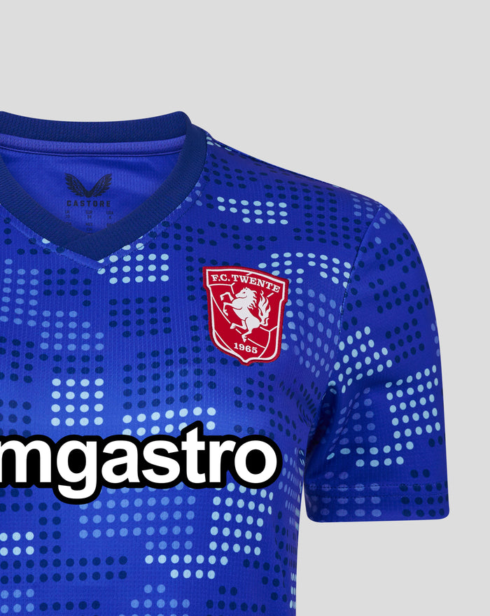 Close-up of FC Twente 25/26 women's away shirt in blue with a stadium wall dot pattern and chest crest