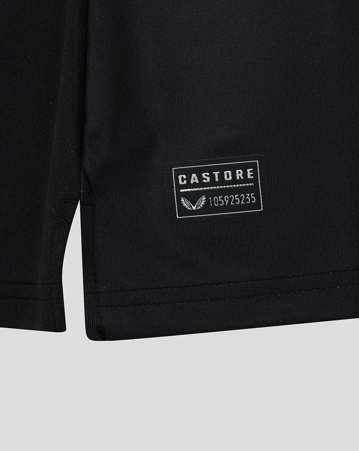 Close-up of the shirt hem featuring a Castore patch with serial number