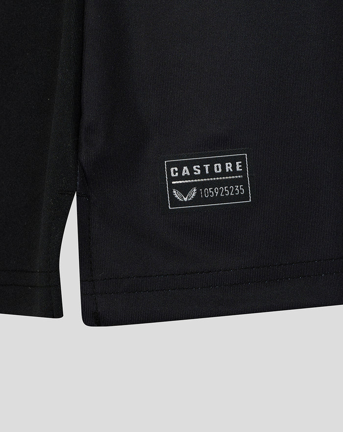 Close-up of the shirt hem featuring a Castore patch with serial number