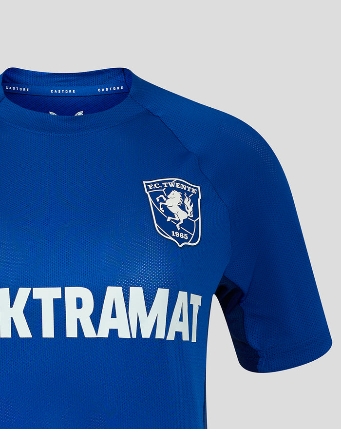 Front close-up of blue women's FC Twente training shirt with crest on the chest and ELEKTRAMAT sponsor text