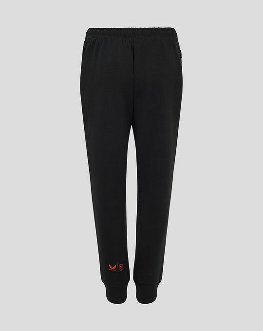 Back view of black FC Twente Travel Pants for women with red branding near the ankle