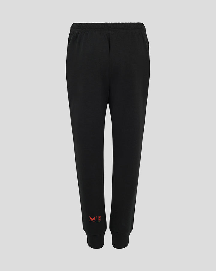 Back view of black FC Twente Travel Pants for women with red branding near the ankle