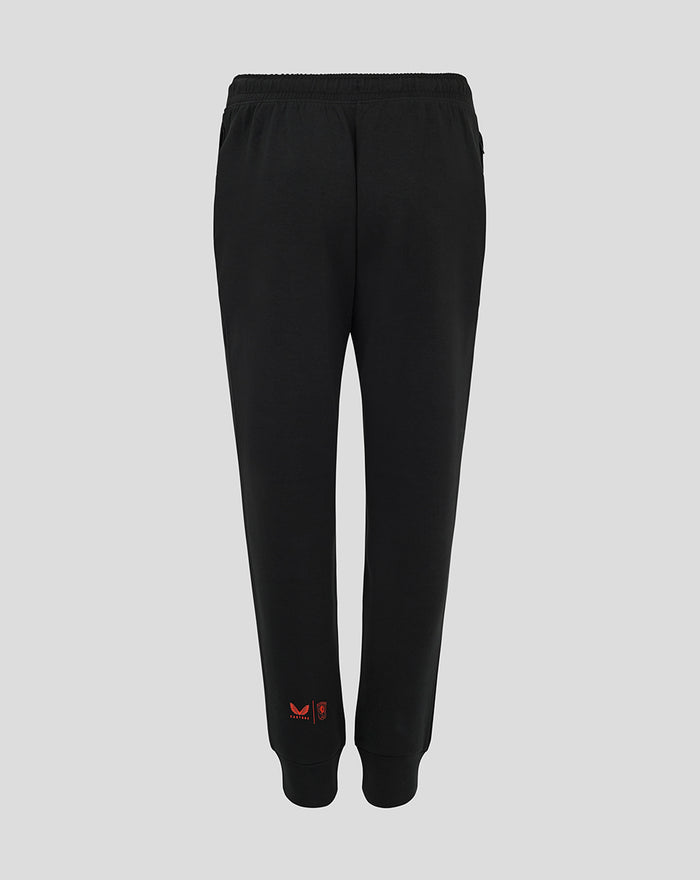 Back view of black FC Twente Travel Pants for women with red branding near the ankle