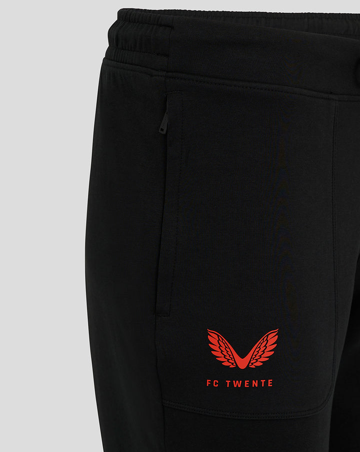 Black FC Twente Travel pants with side zip pockets and red Castore wings logo on the thigh.