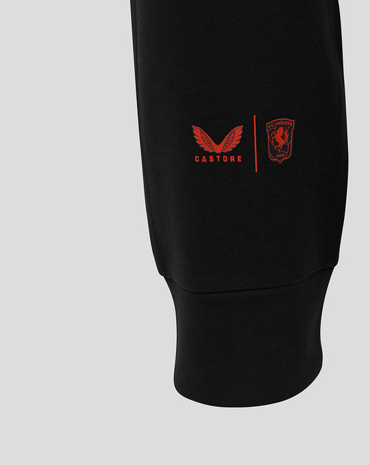 Close-up of black FC Twente Travel pants displaying Castore wings and club crest on the thigh.