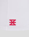 Close up of white fabric with a pink FC Twente logo near the hem