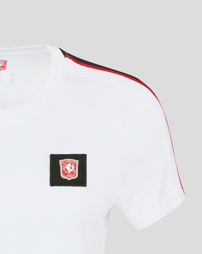 Close-up of white FC Twente T shirt showing red and black shoulder stripe and crest patch.