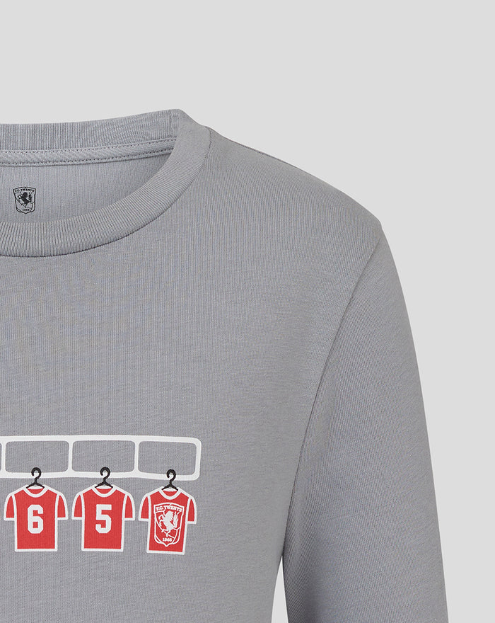 Grey FC Twente dressing room T shirt with red numbered jerseys hanging on a rack