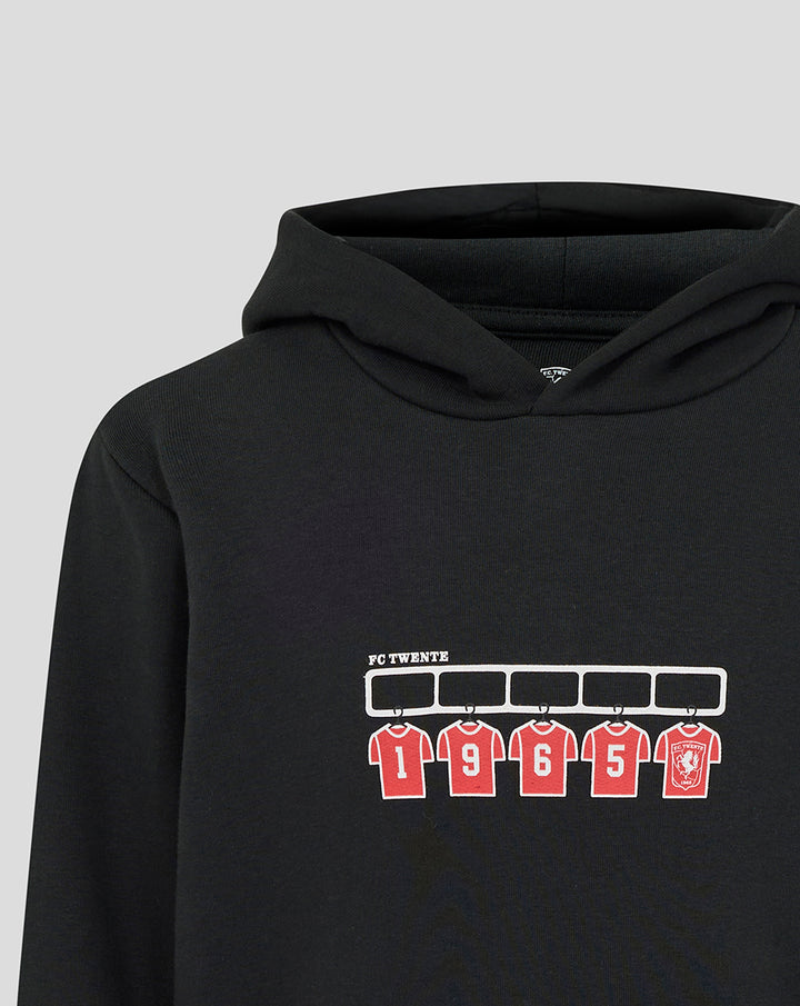 Detail of chest print on black FC Twente hoodie with red numbered jerseys and crest
