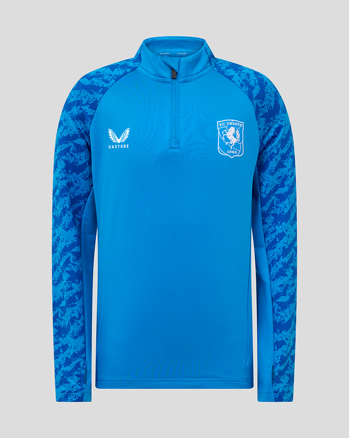 Front view of blue FC Twente midlayer top with crest on the left chest, Castore logo and camo patterned sleeves