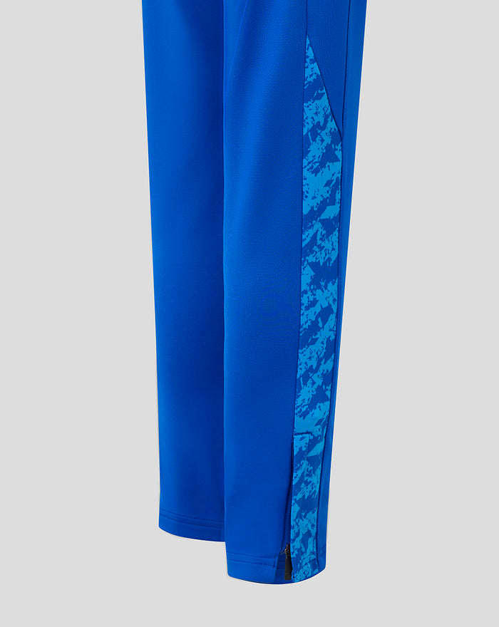 Lower leg close up of blue FC Twente pants showing patterned side panel and zipper at the ankle.