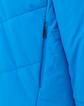 Detail of a blue FC Twente jacket featuring a vertical zipper pocket and seam lines.