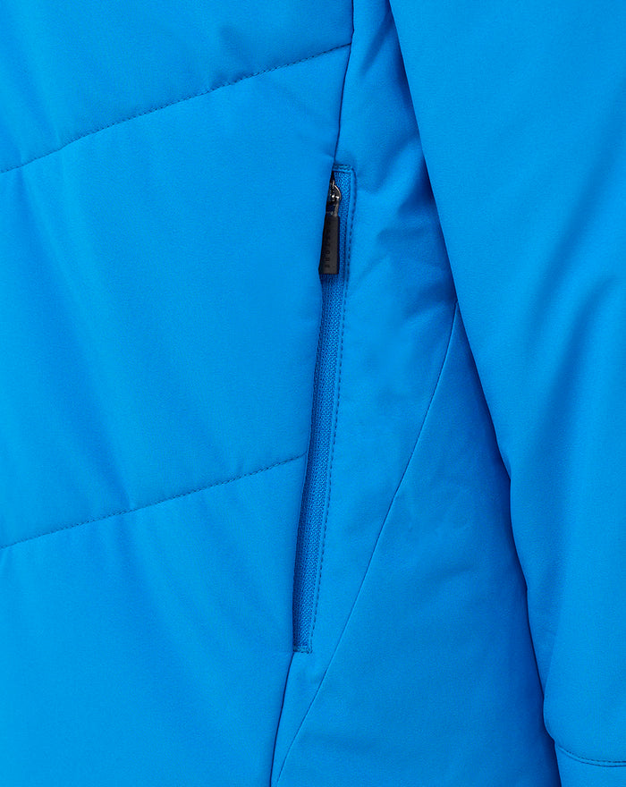 Detail of a blue FC Twente jacket featuring a vertical zipper pocket and seam lines.