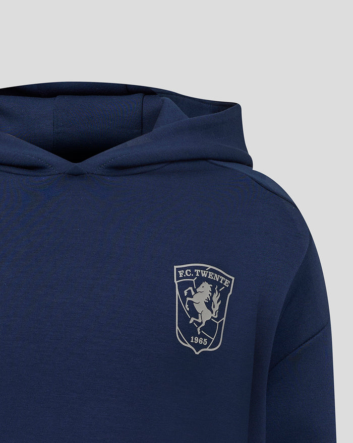 Front view of navy FC Twente Travel Overhead Hoody junior with a crest on the left chest.