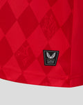 Hem area of the red FC Twente home shirt with an authentic Castore product badge.