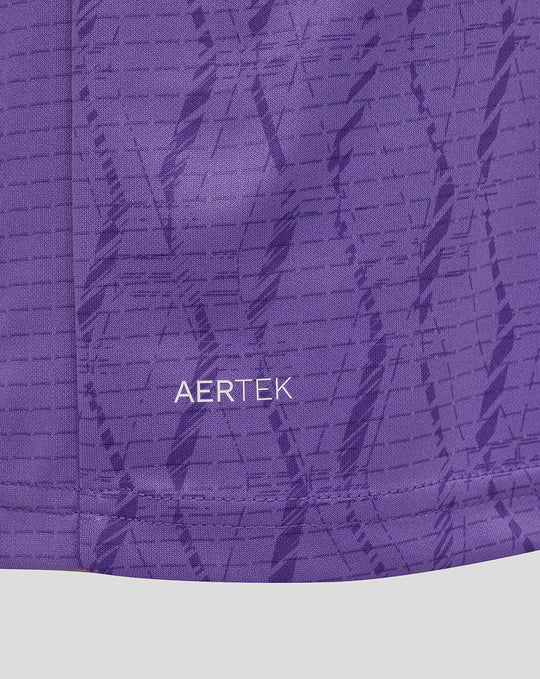Purple fabric close-up showing AerTek branding on the garment.