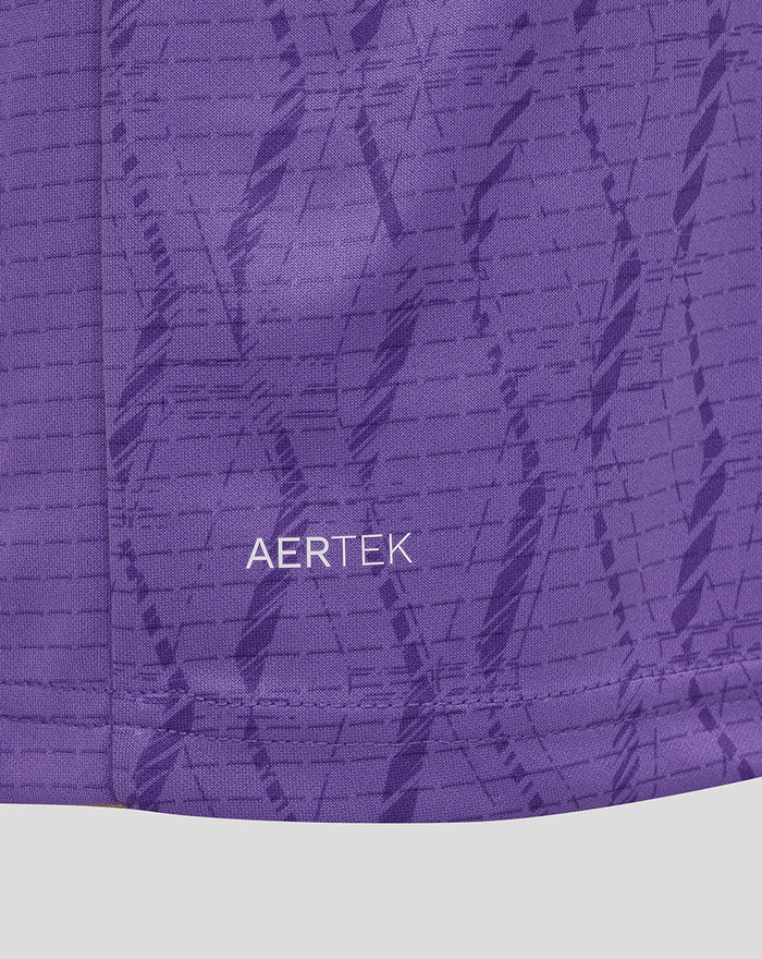 Purple fabric close-up showing AerTek branding on the garment.