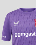 Close up of purple FC Twente keepers shirt with crest on chest and Castore branding amid a geometric pattern.