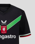 Close up of FC Twente third shirt 25/26 junior with black fabric green diagonal chevron crest and striped sleeve trim.