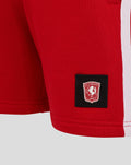 Red FC Twente junior shorts close up with crest patch and rear pocket