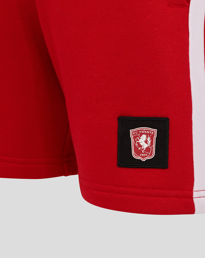Red FC Twente junior shorts close up with crest patch and rear pocket