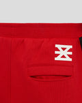 Red FC Twente junior shorts waistband close up with white emblem and back pocket