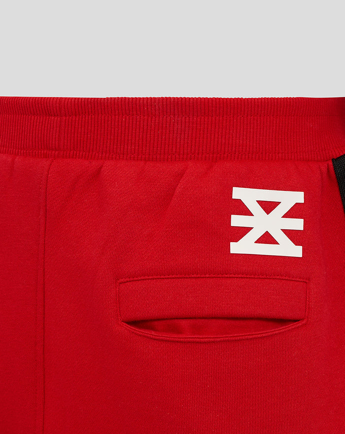 Red FC Twente junior shorts waistband close up with white emblem and back pocket