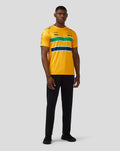 Front view of a man wearing a yellow Ayrton Senna Monaco T Shirt with green and navy stripes and sponsor logos on the chest.