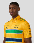 Close up of a male model wearing a yellow McLaren Monaco polo, highlighting the collar and printed sponsor logos.