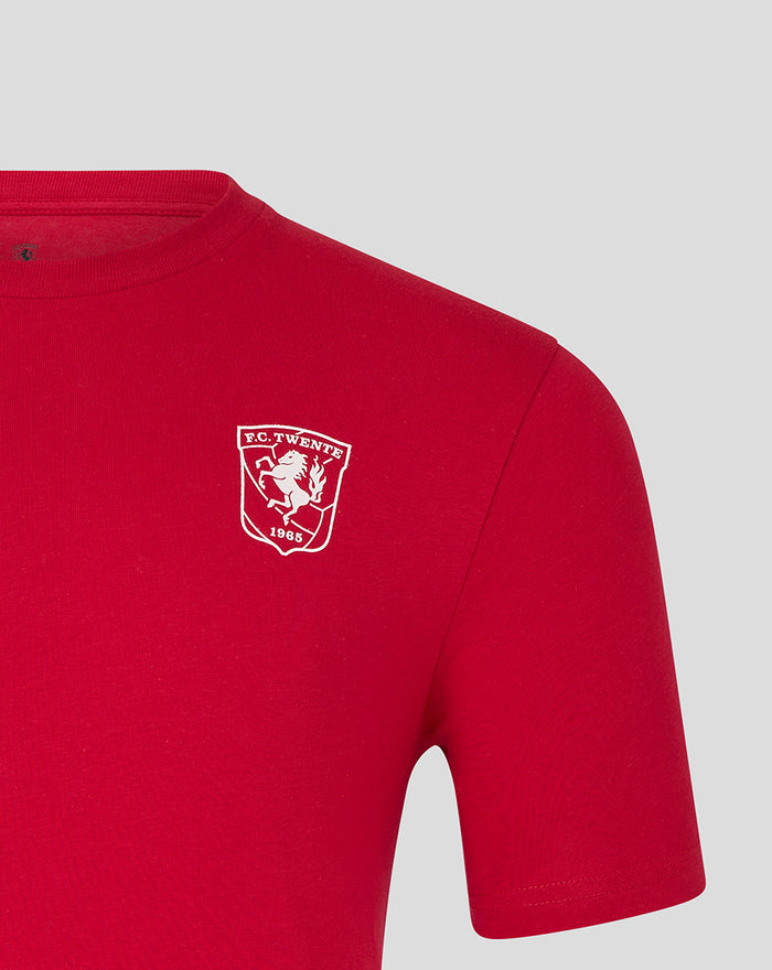 Close up of white FC Twente crest on red T-shirt chest area